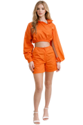Woman wearing an orange outfit on a white background