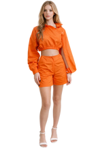 Woman wearing an orange outfit on a white background