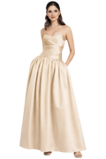 Woman wearing a gold strapless gown on a white background