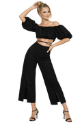 Woman wearing a black outfit with wide-leg pants and a top with puffed sleeves on a white background