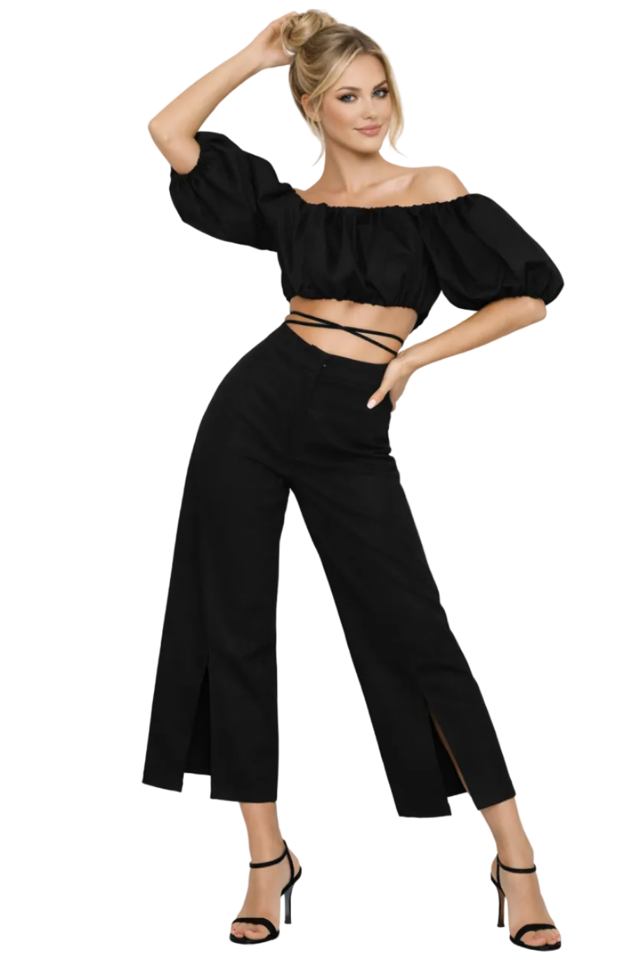 Woman wearing a black outfit with wide-leg pants and a top with puffed sleeves on a white background