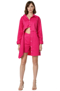 Woman wearing a bright pink outfit with a shirt and shorts on a white background