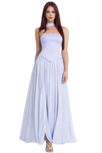 Woman wearing a light blue strapless gown on a white background