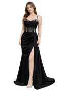 Woman wearing a black evening gown with a high slit on a white background