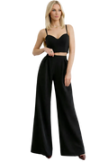 Woman wearing a black outfit with wide-leg pants on a white background