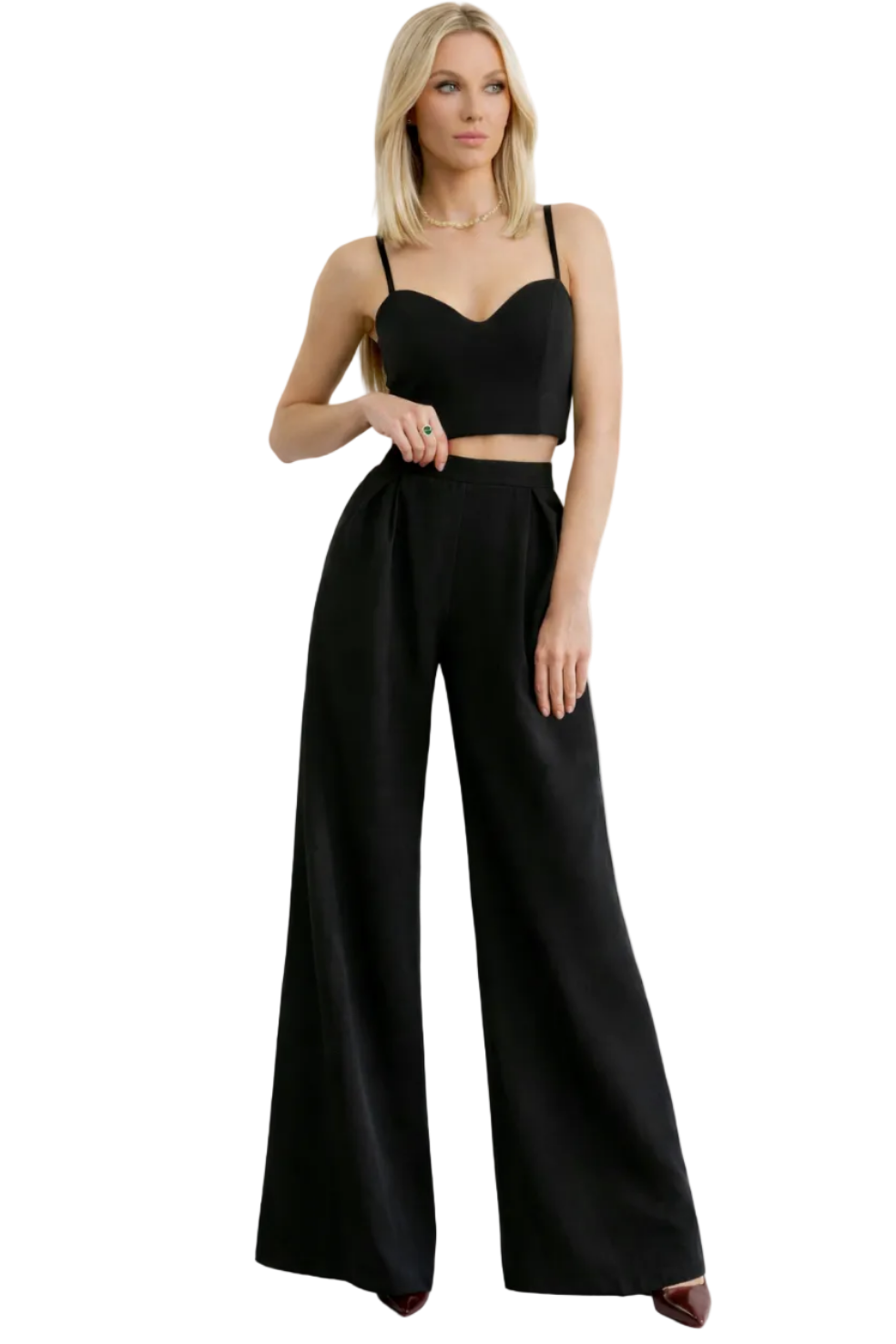 Woman wearing a black outfit with wide-leg pants on a white background
