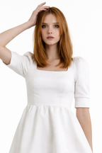 Woman wearing a white dress on a white background