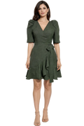 Woman wearing a green dress with a white background