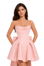 Woman wearing a pink strapless dress on a white background