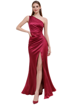 Woman wearing a red one-shoulder evening gown on a white background