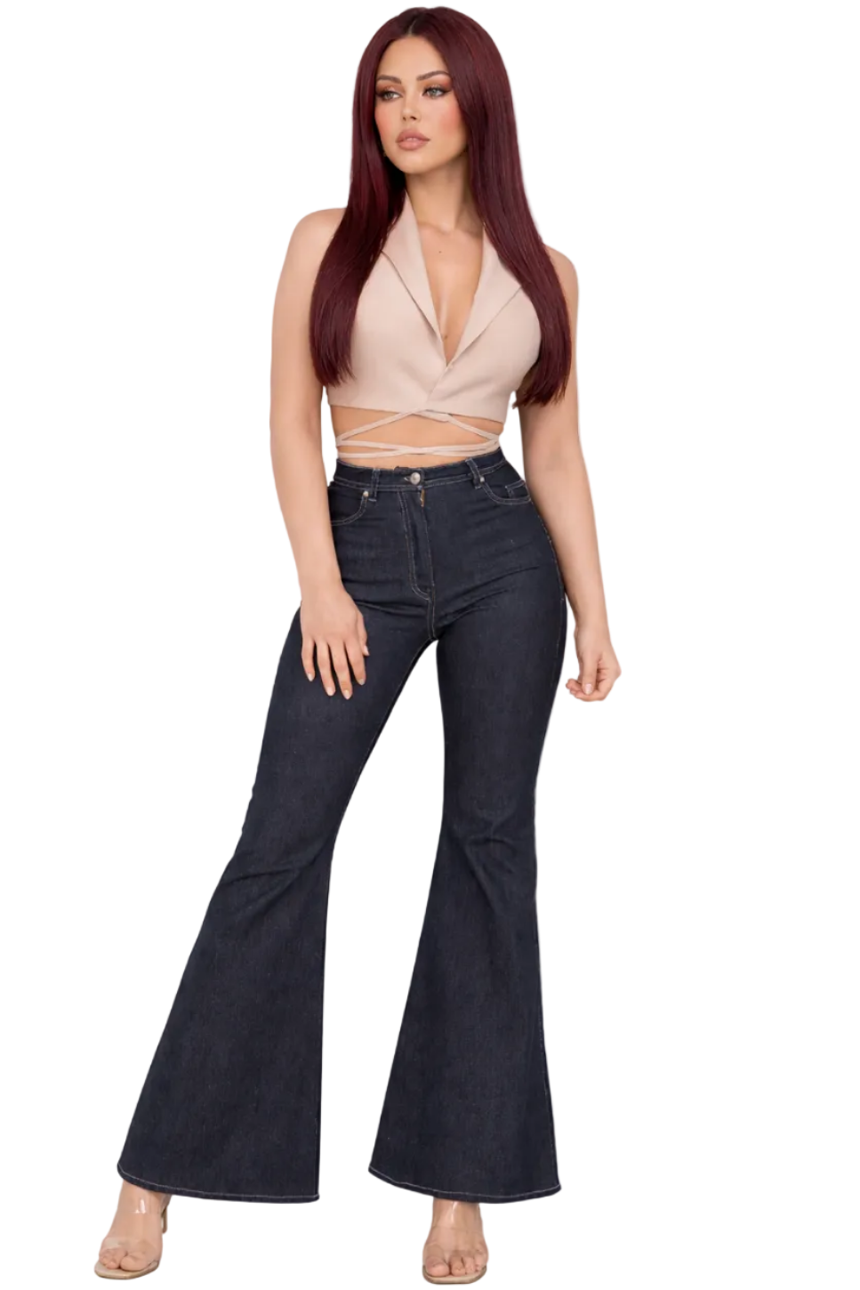 Woman wearing a beige top and black flared jeans on a white background