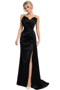 Woman wearing a black evening gown with a slit on a white background
