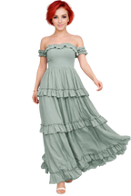 Woman wearing a light green off-shoulder ruffled dress on a white background