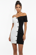 Woman wearing a black and white off-shoulder dress on a white background