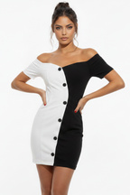 Woman wearing a black and white dress with button details on a white background