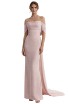Woman wearing a pink off-shoulder gown on a white background