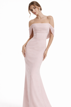 Woman wearing a pink off-shoulder gown on a white background