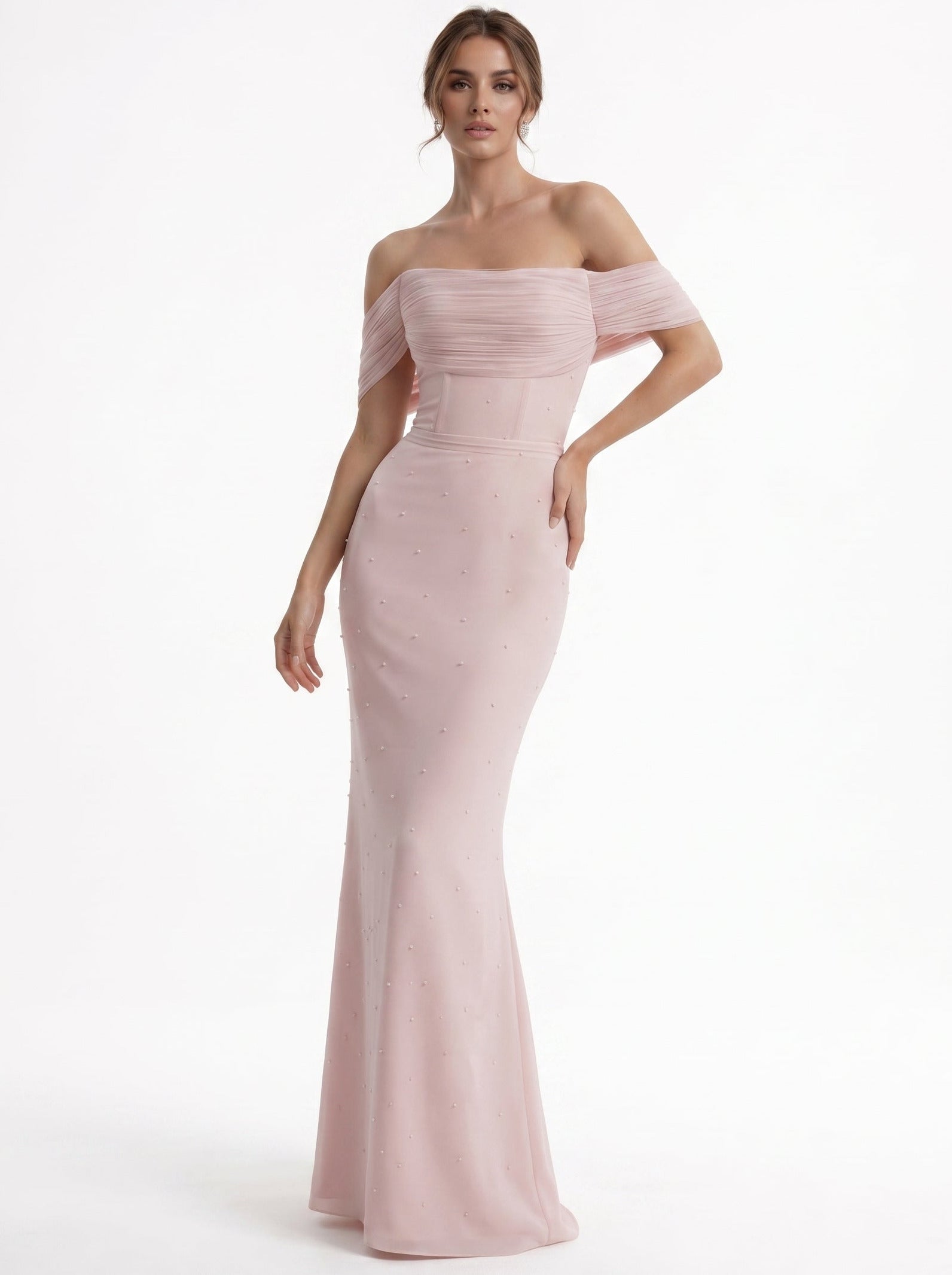 Woman wearing a pink off-shoulder gown on a white background