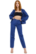 Woman wearing a blue denim outfit on a white background