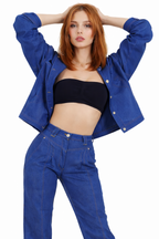 Woman wearing a blue jacket and jeans on a white background