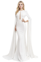 Woman wearing a white evening gown with long sleeves on a white background