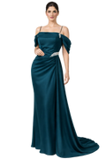 Woman wearing a teal evening gown with a white background