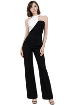 Woman wearing a black and white jumpsuit on a white background