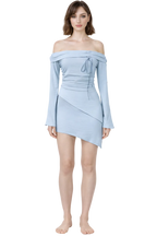 Woman wearing a light blue off-shoulder dress on a white background